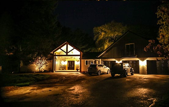 house with exterior landscape lighting