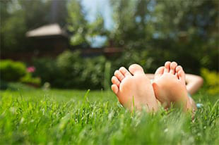 Person laying on the grass of a home