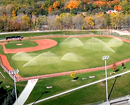 Irrigation systems on a baseball field, watering the outfield grass